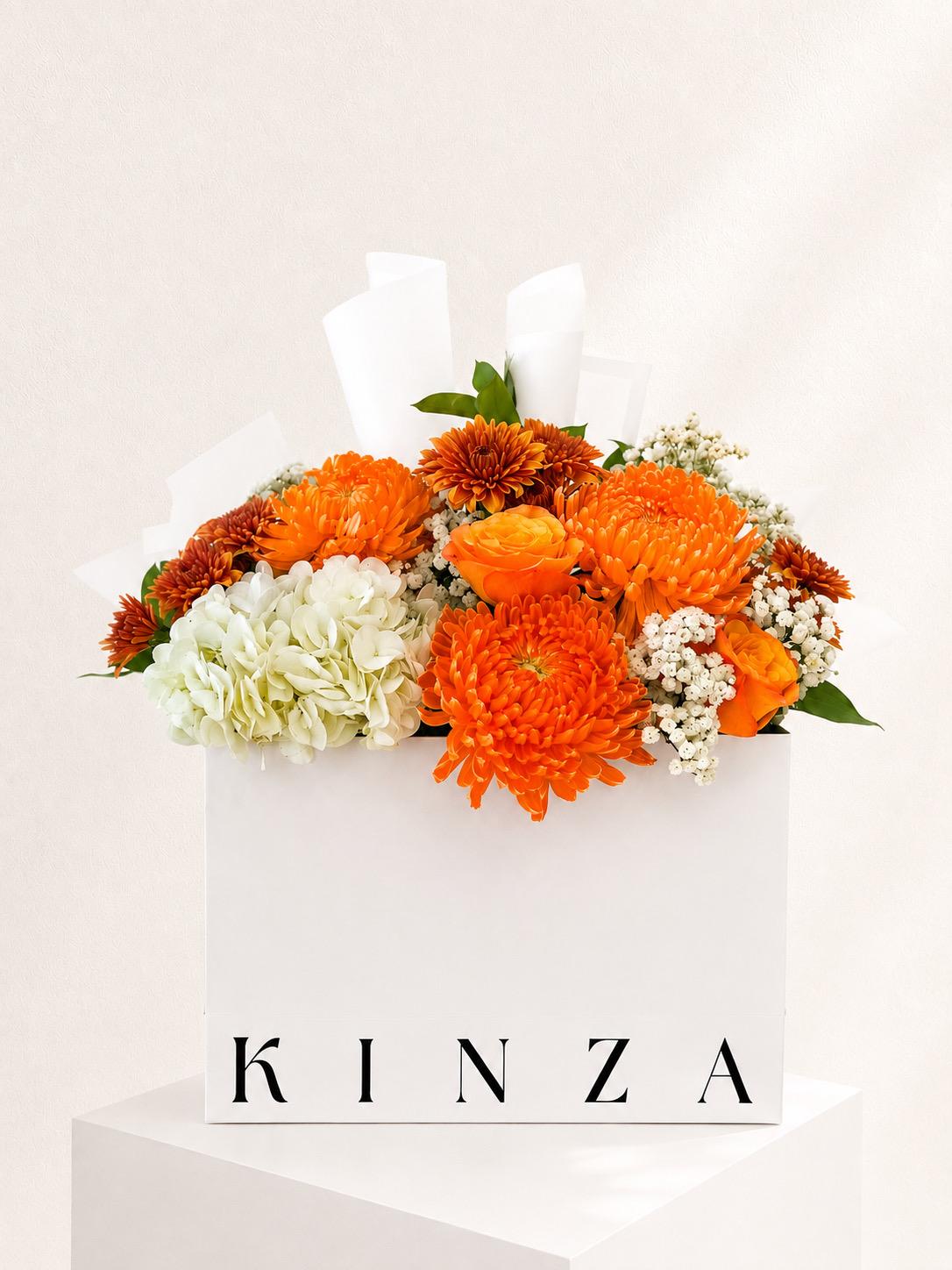 Signature Kinza White Bag Floral Arrangement - Amber Glow