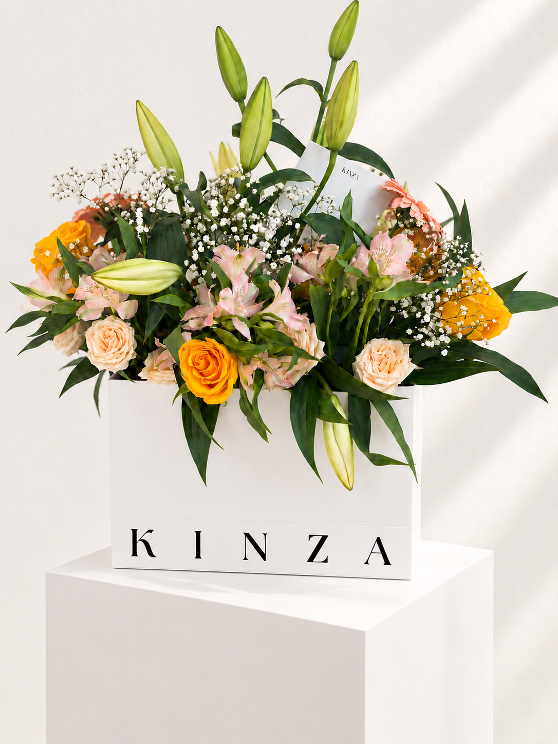 Signature Kinza White Bag Floral Arrangement - Golden Lily Meadow